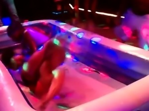 Women stripping one another oil wrestling