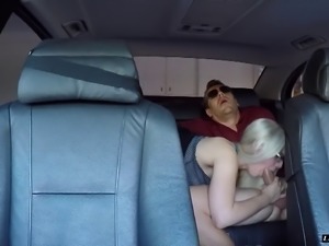Hot blonde in a miniskirt rides a big cock in his back seat