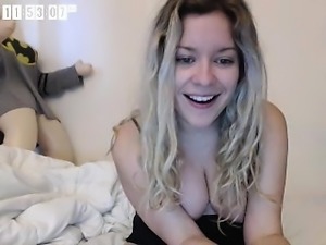 Pretty young blonde in sexy black lingerie smiles and laugh