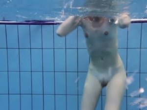 Blonde sexpot swimming half naked in the pool