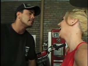 Blonde chick riding on a long shaft while sucking the other one