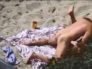 Tanned dark haired slutty bitch was topping her man's dick on the beach