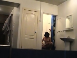 Hidden camera shows a hot brunette in the shower