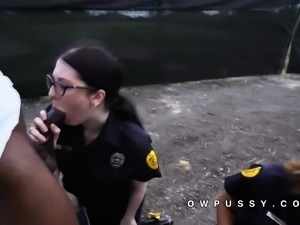 Two female police strip a black man