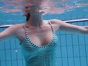 Busty redhead European babe spreads her legs under water