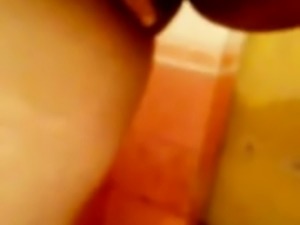 Sexy co-ed with big boobies masturbating passionately in the bathroom