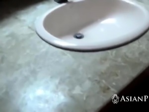 Busty Asian girlfriend sucks dick in the bathroom