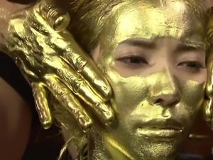 japanese submissive in gold body paint fingers her pussy