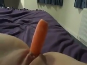 I fuck my shaved pussy with carrot spreading legs wide