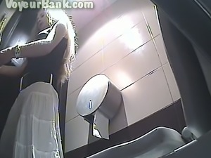 Hot blonde babe in the public restroom shows her goodies on hidden cam