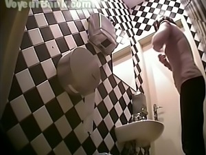 Busty brunette white woman in the ladies room pisses