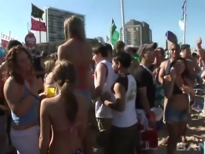 Frivolous tanned girls are dancing and sucking each others nipples on the beach