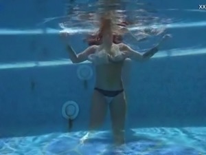 Beautiful mermaid Puzan Bruhova swims and kinda strips underwater