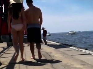Beach voyeur follows a slender Asian beauty in a pink bikini