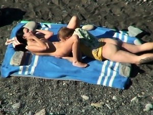 Voyeur video of sexy brunette nude hottie at the beach