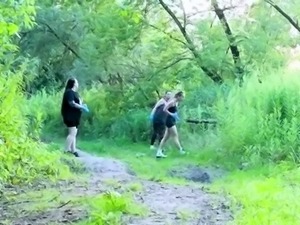 Strapon mistresses punishing masked slave in the woods